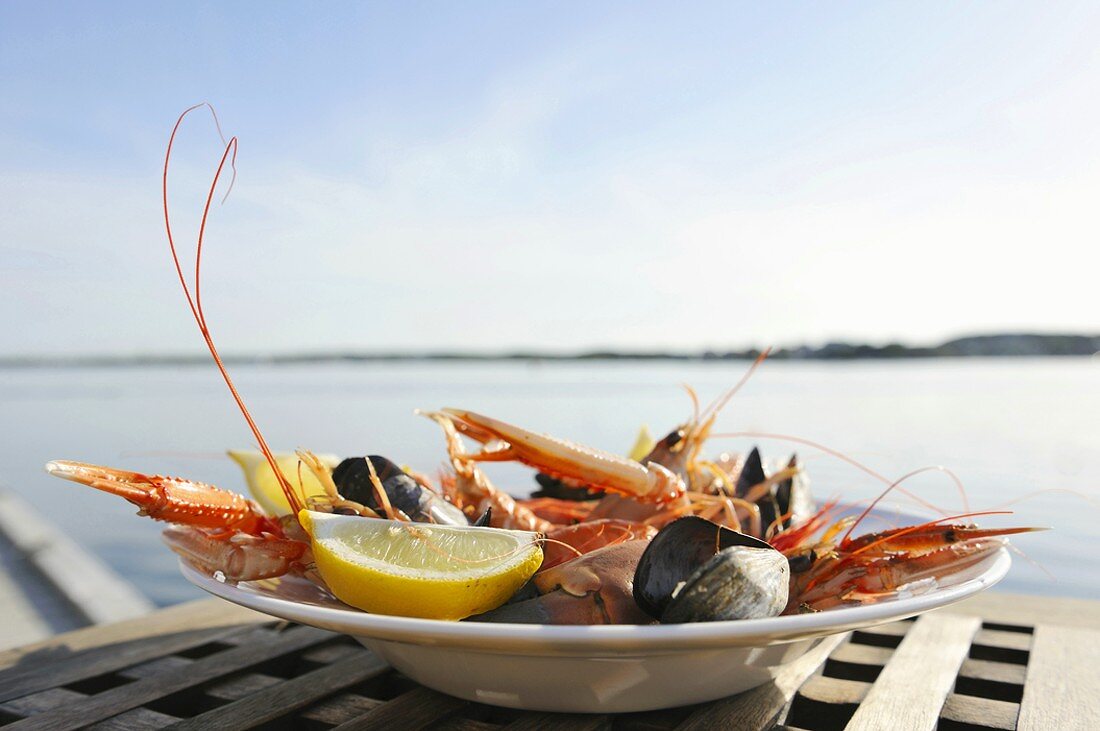 Plate of seafood on plate by sea