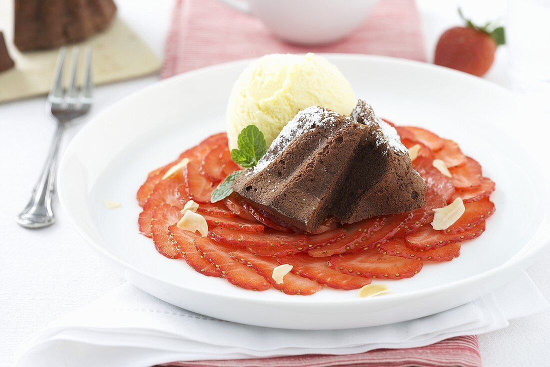 Chocolate cake on strawberry carpaccio with vanilla ice cream