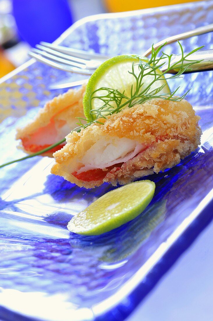 Deep-fried crabmeat with coconut coating, lime slices