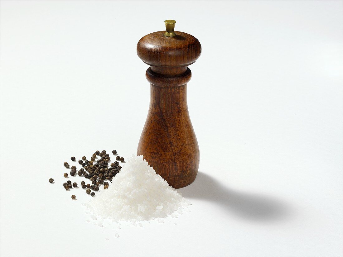 Salt and peppercorns with pepper mill