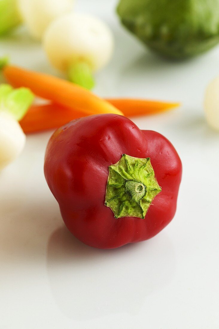 Red pepper, carrots, turnips etc. in background