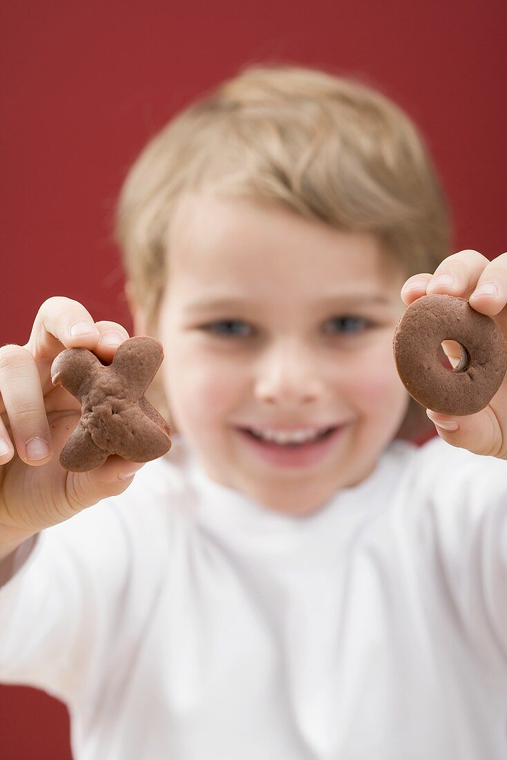 Little boy holding XO biscuits