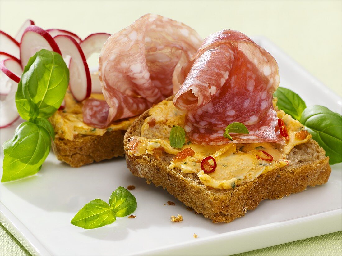 Tomato and chilli butter and salami on bread
