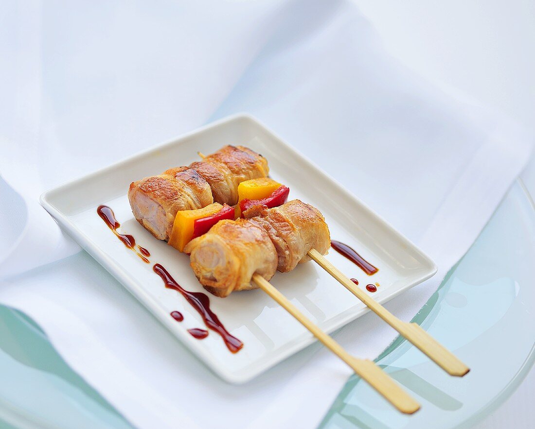 Bacon-wrapped pork and vegetable skewers, balsamic vinegar