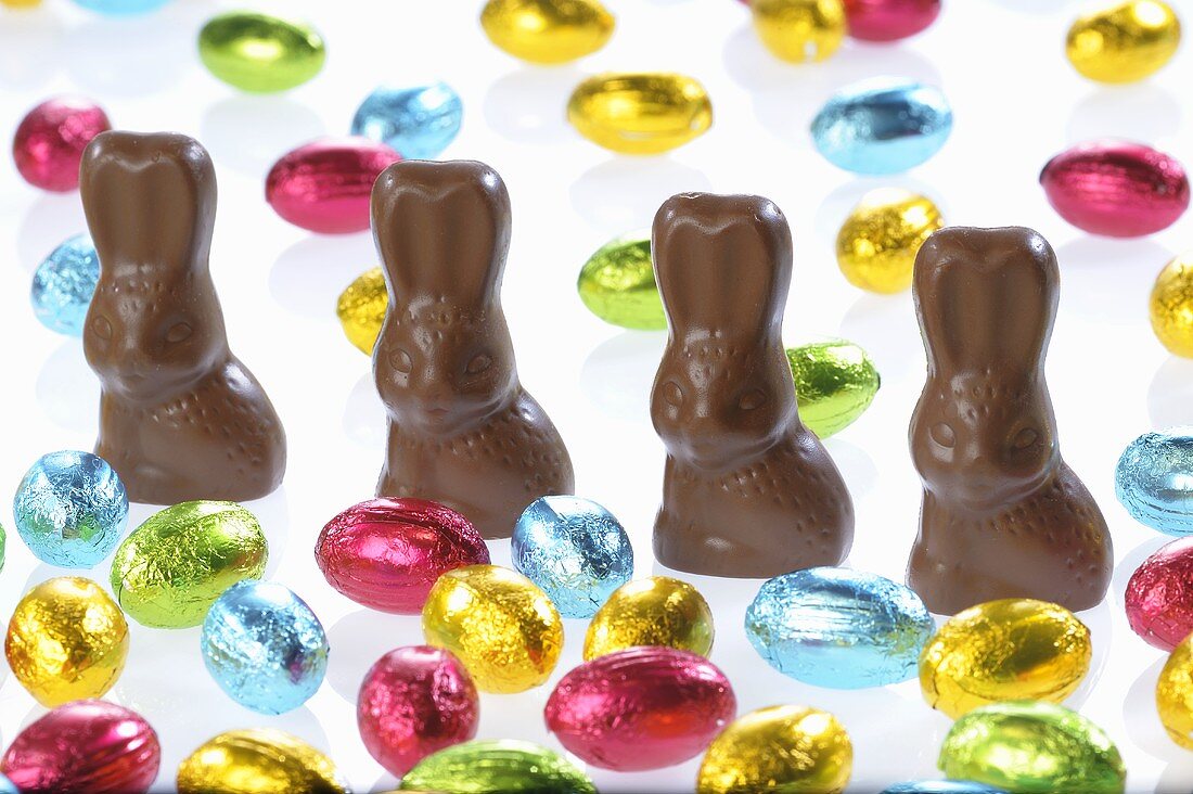 Chocolate bunnies and small chocolate eggs in coloured foil