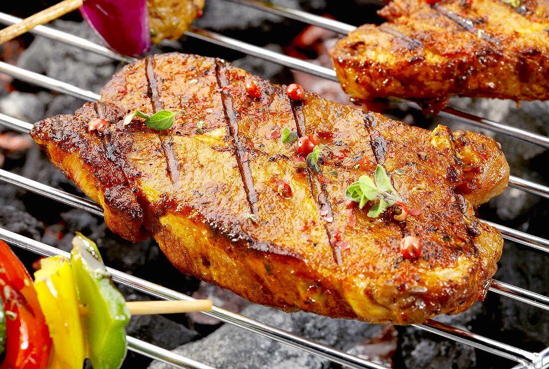 Pork neck steaks on barbecue