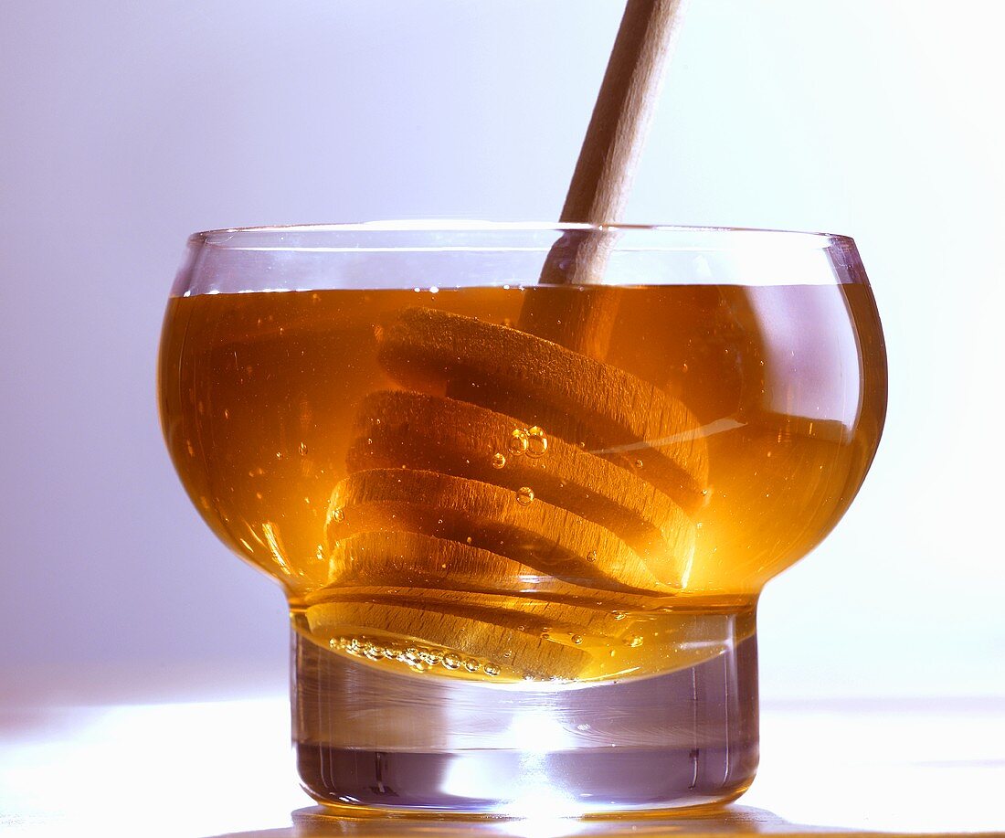 Honey in glass with honey dipper