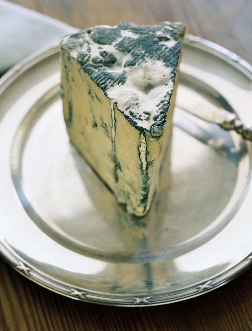 Piece of blue cheese on silver plate