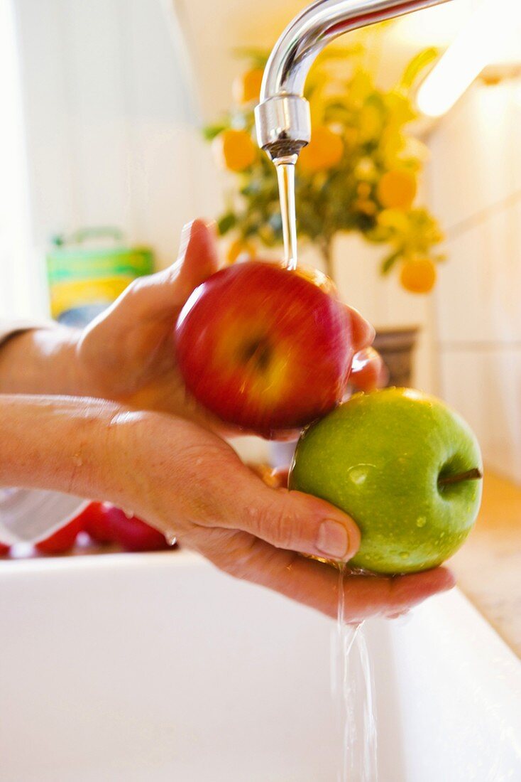 Washing apples over sink