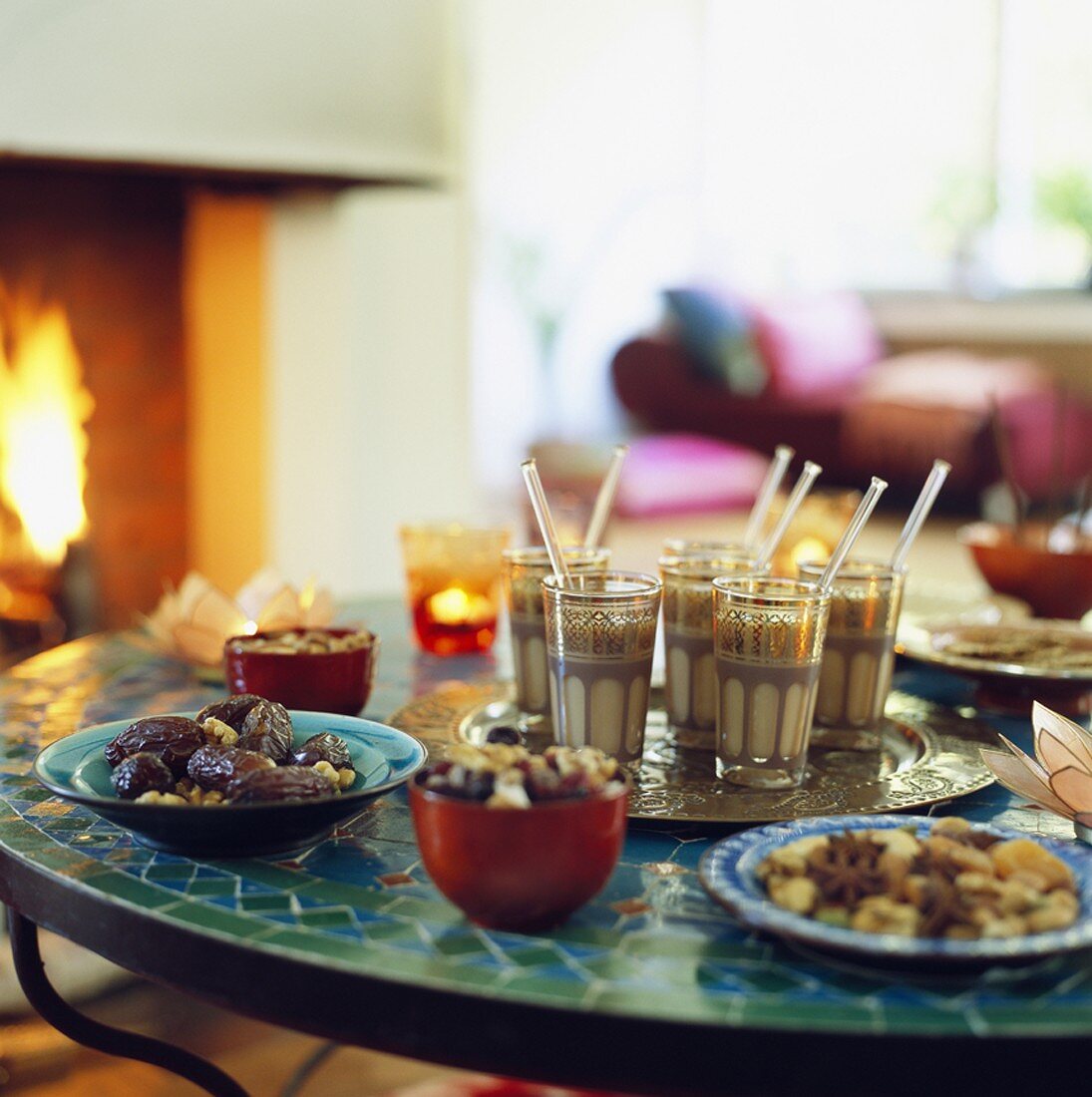 Coffee and snacks on table in front of fire