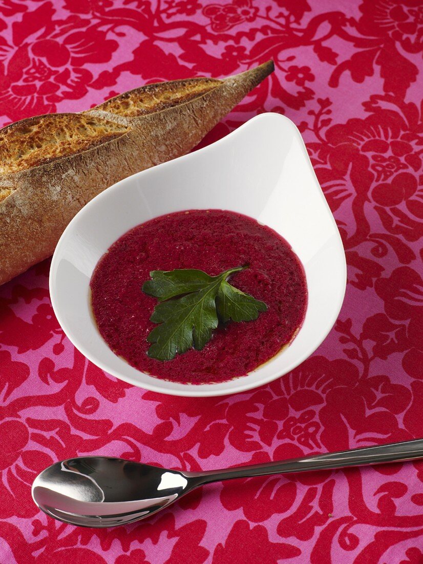 Red beet soup with parsley, bread