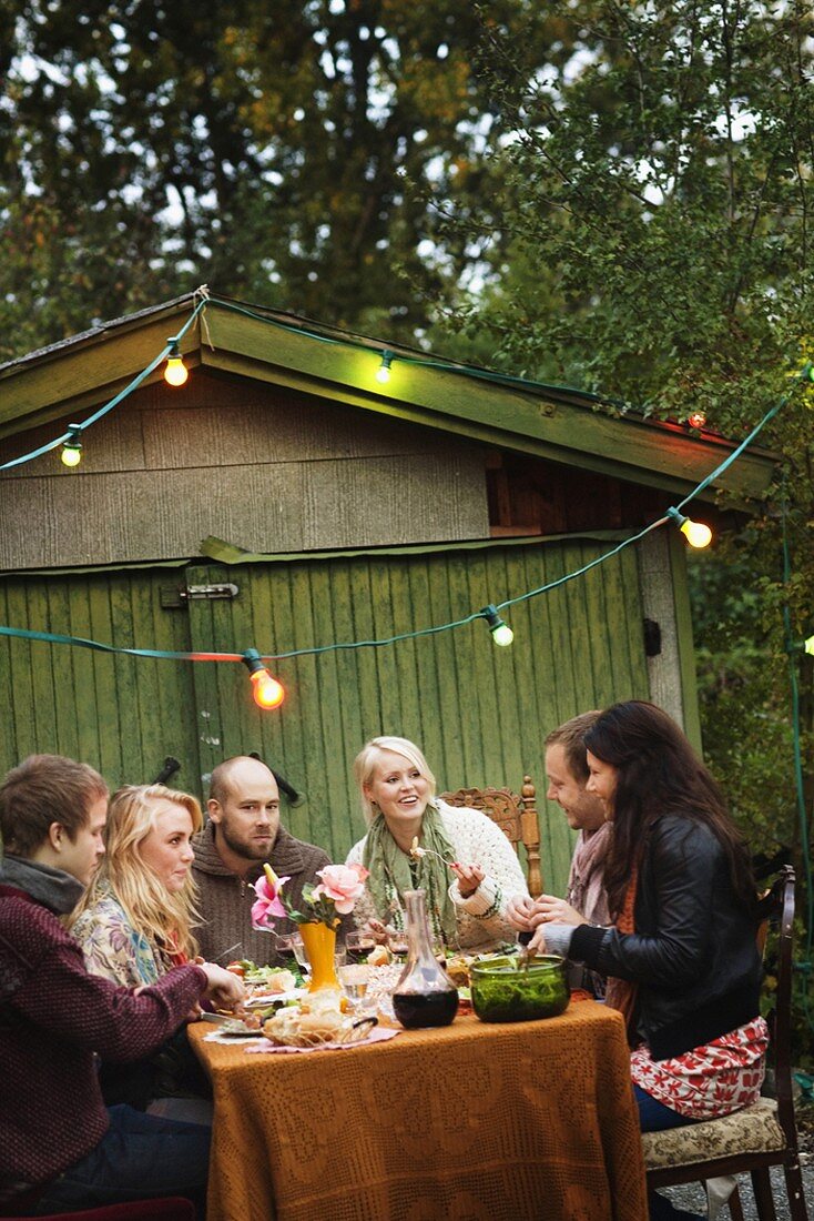 Family eating in an autumn garden