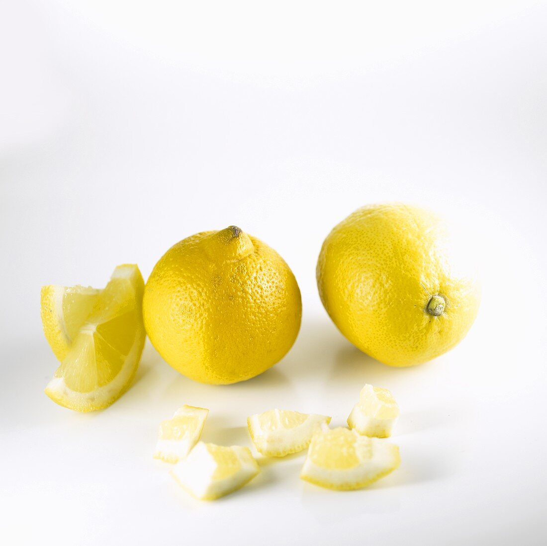 Two lemons and pieces of lemon