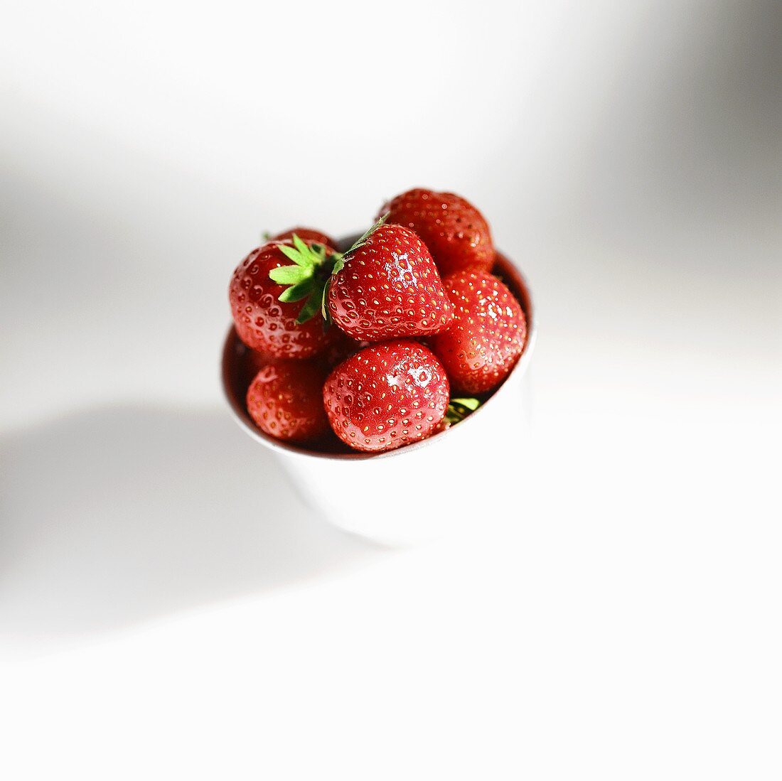 Fresh strawberries in a small bowl