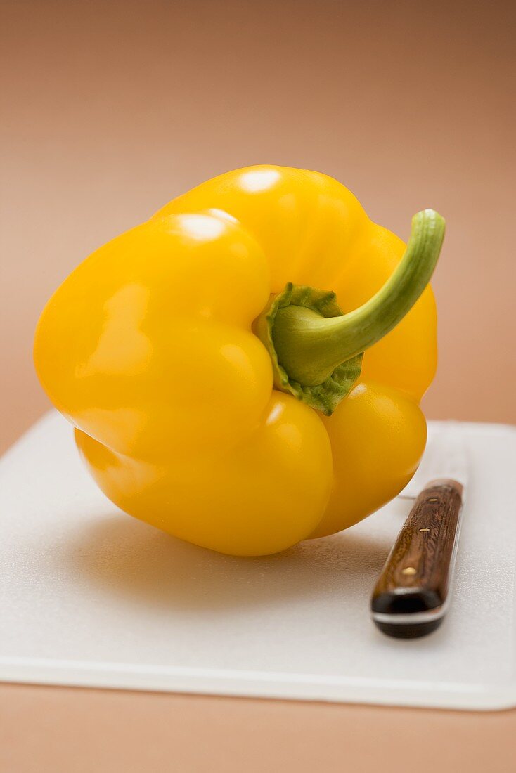 Pepper on chopping board with knife