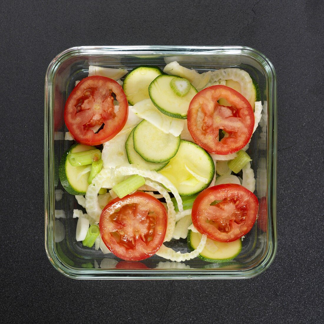 Sliced vegetables in glass dish (overhead view)