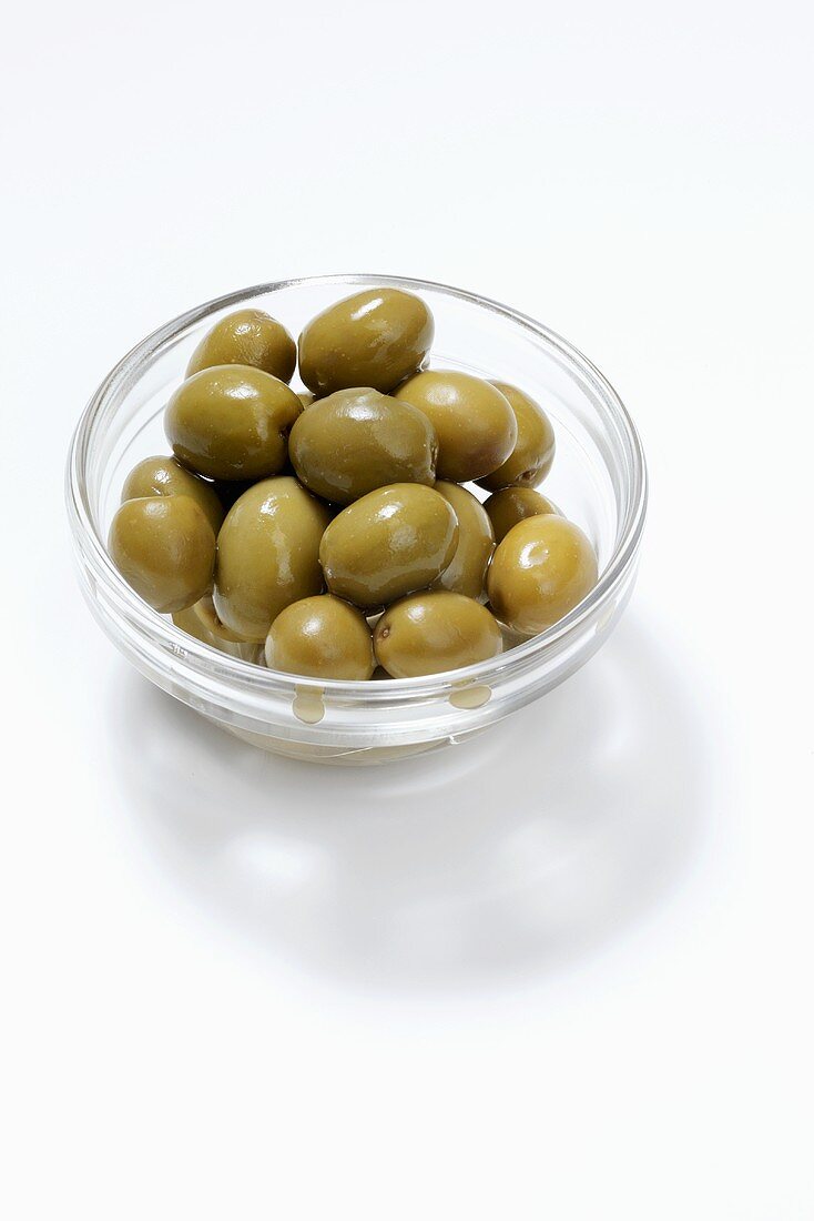 Green olives in small glass dish