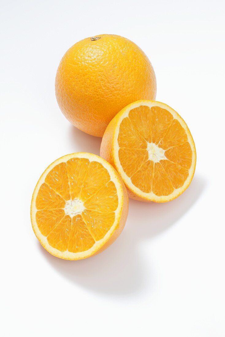 A whole orange and a halved orange
