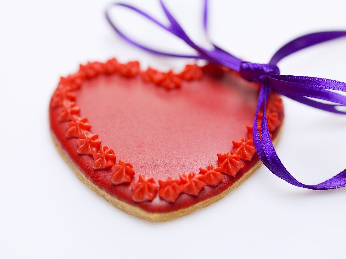 Red heart-shaped biscuit with bow