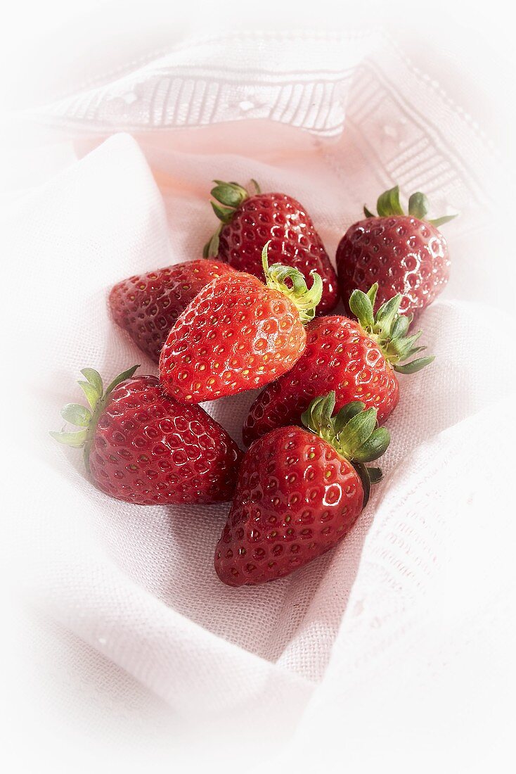 Fresh strawberries on white cloth