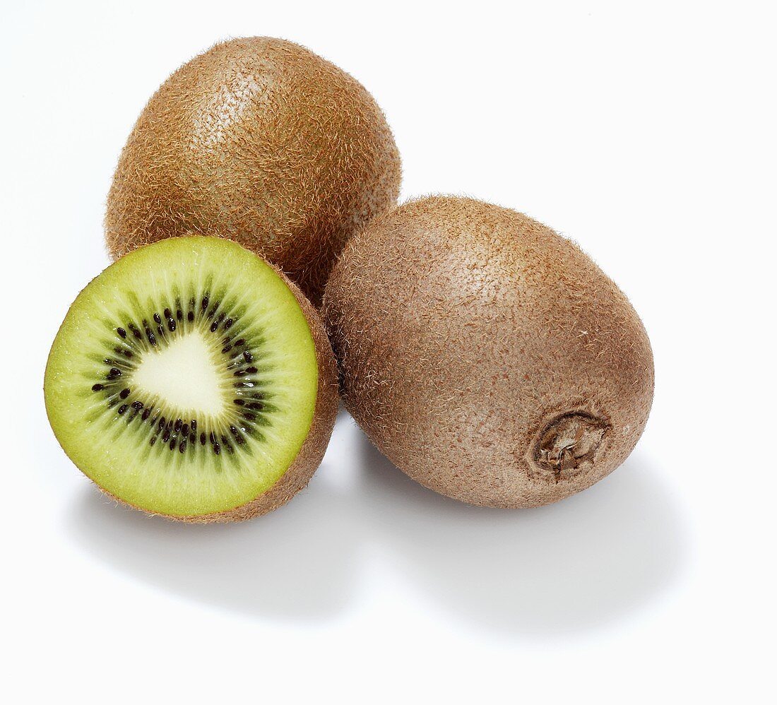Kiwi fruits and half a kiwi fruit