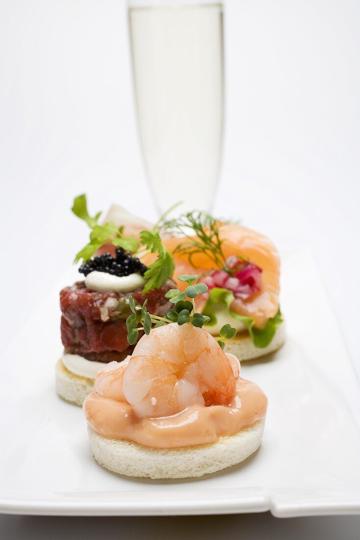 Assorted canapés and glass of sparkling wine