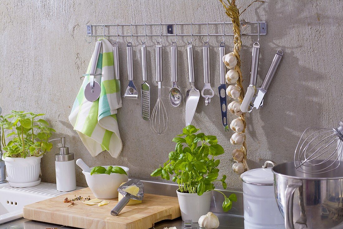 Kitchen utensils, string of garlic, basil, Parmesan etc.