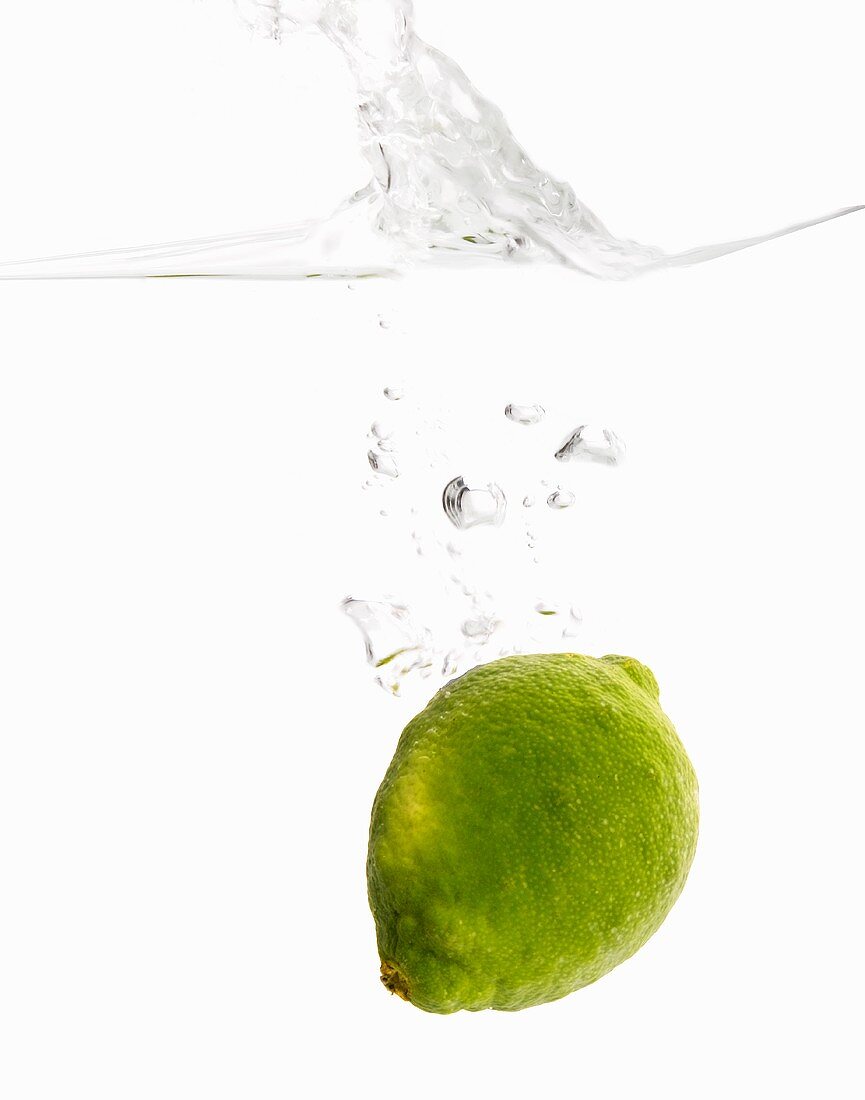 Whole Lime Dropping into Water