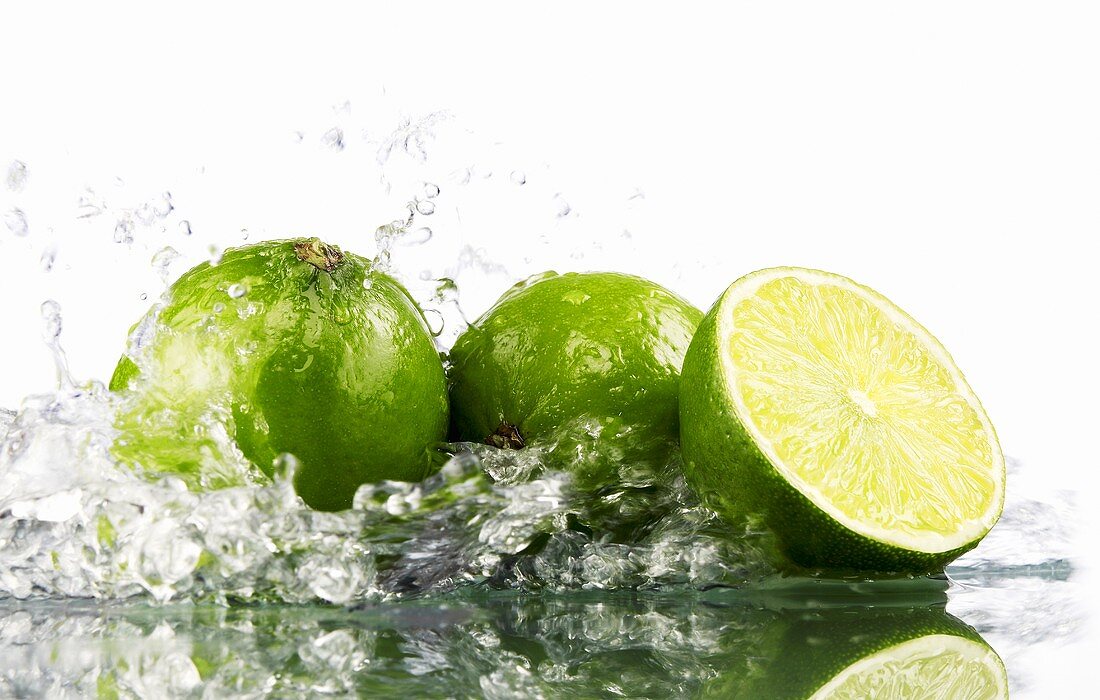 Limes with splashing water