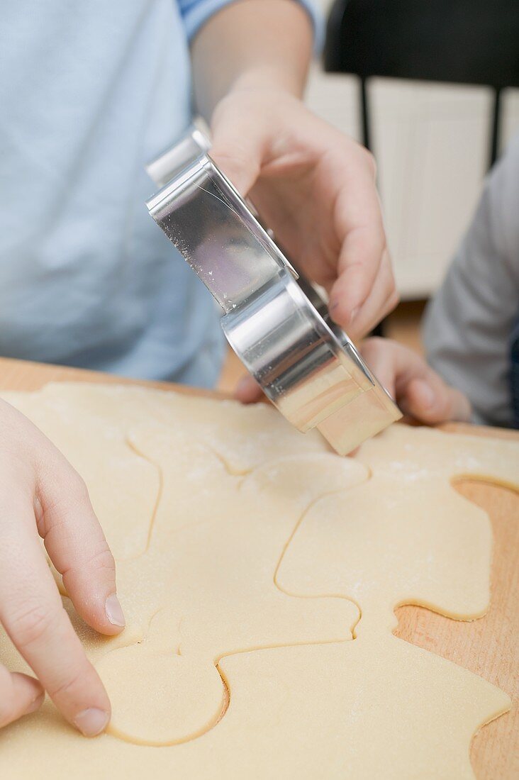 Children cutting out biscuits