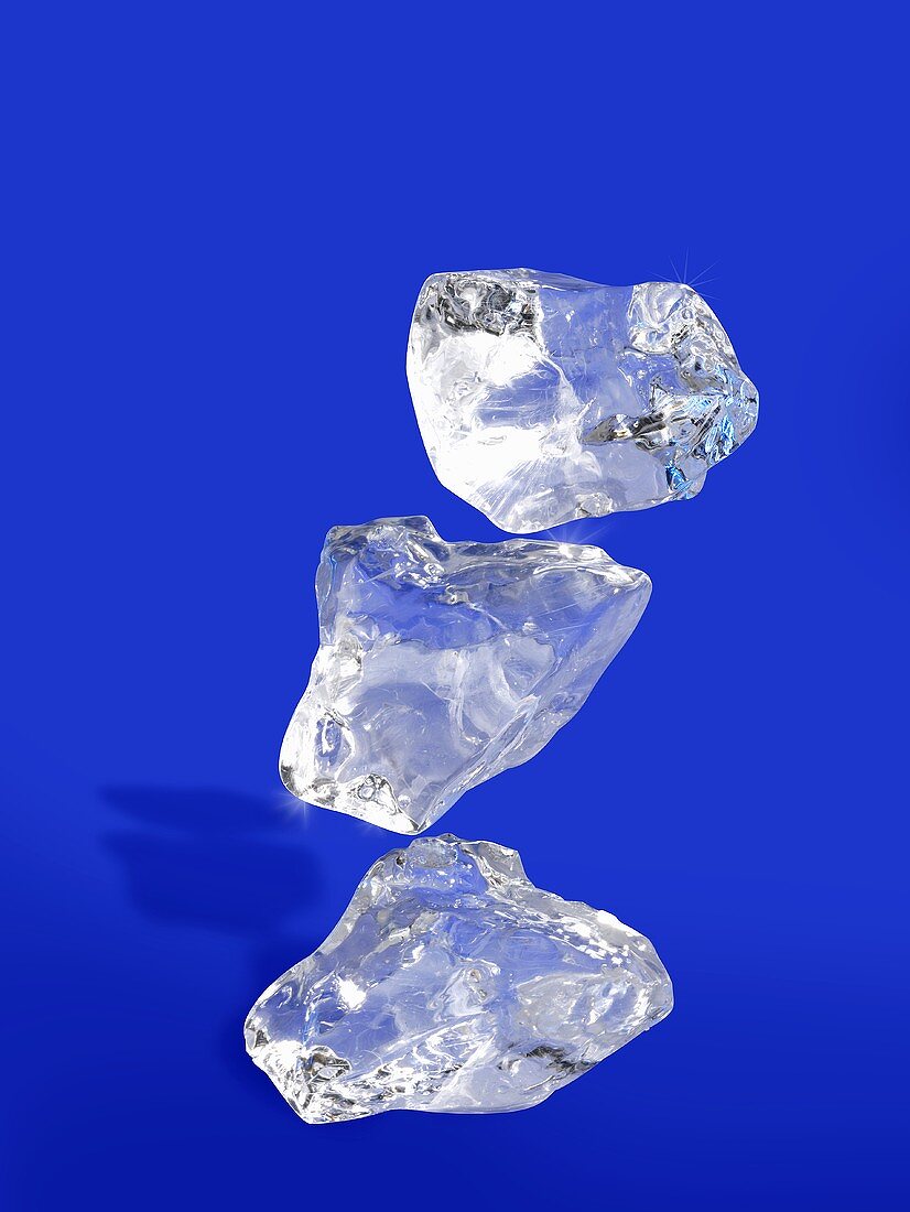 Three ice cubes on blue background