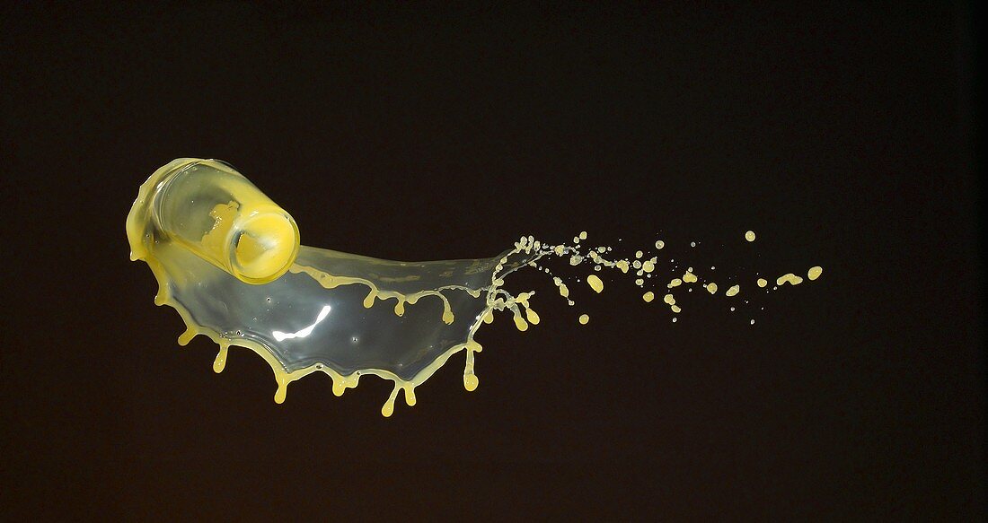 Orangensaft spritzt aus fallendem Glas