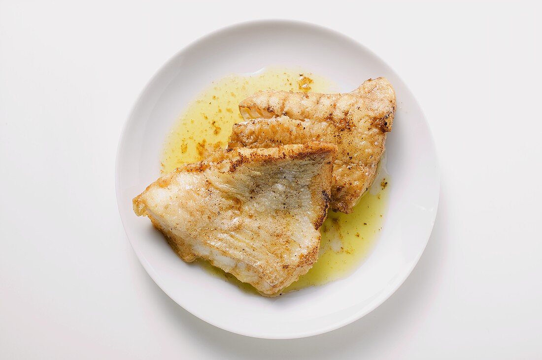 Fried fish fillets on plate