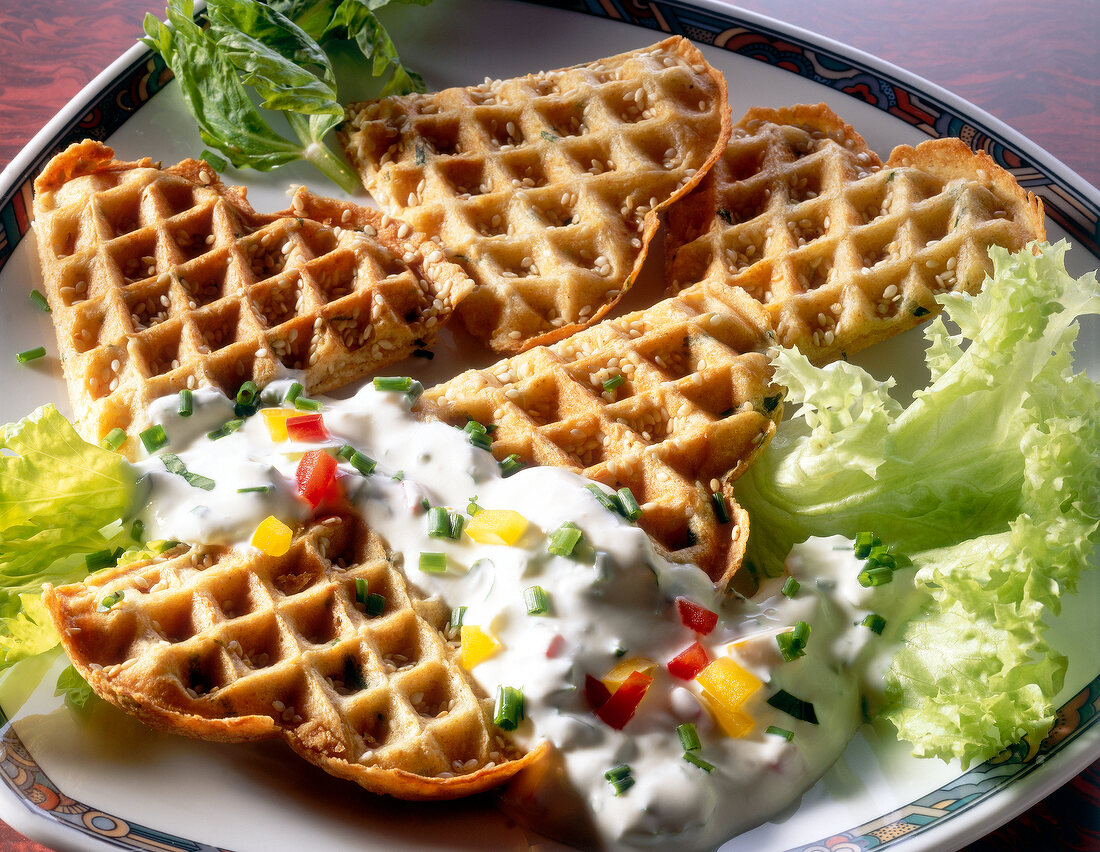 Waffles with cottage cheese, vegetable sauce and peppers on plate