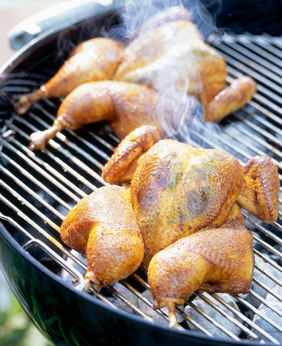 Two whole chicken on grill for barbecue