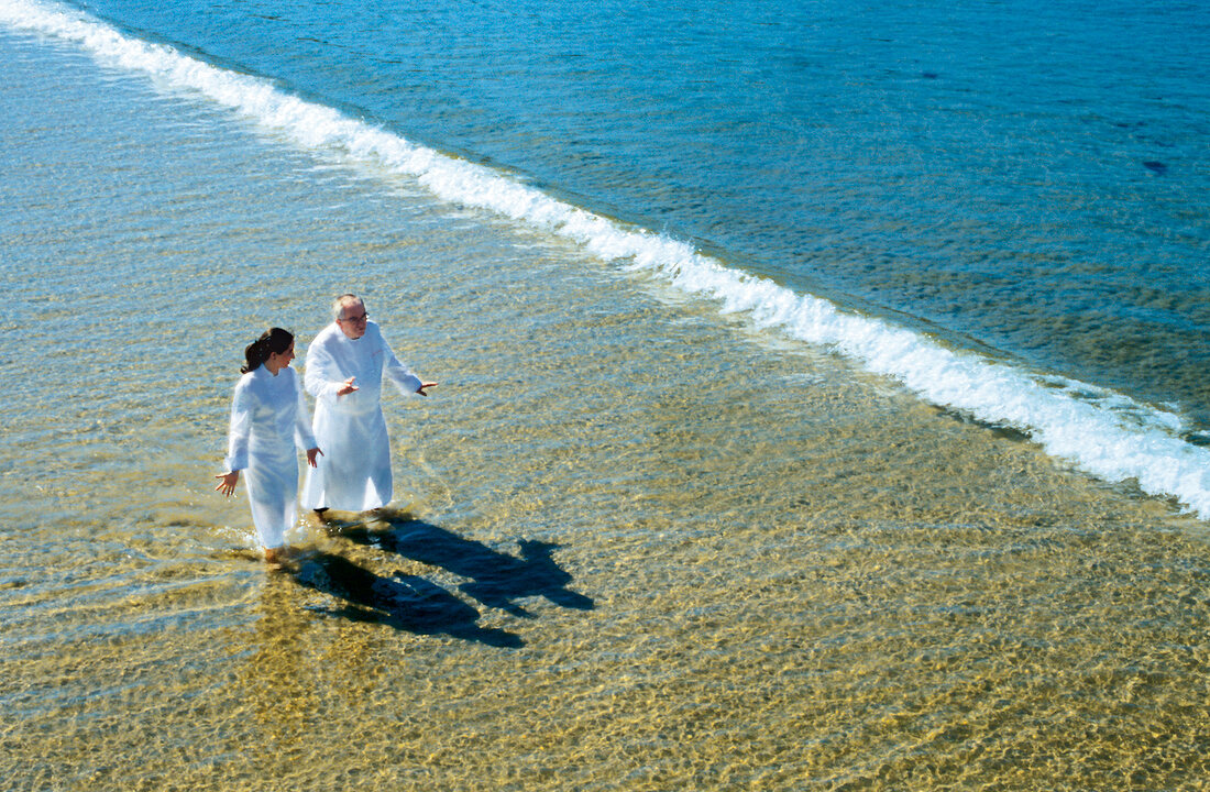 Juan Mari Arzak and Elena Arzak walking on beach, Elevated view, Spain