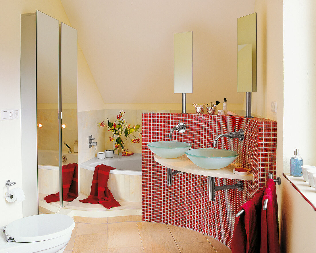 Interior of bathroom with two bowl sinks and red mosaic wall