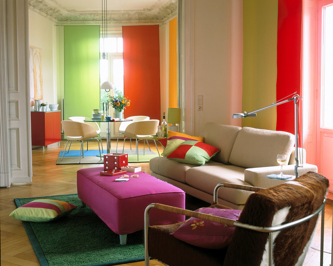 Colourful living room with sofa, table, floor lamp and cushions