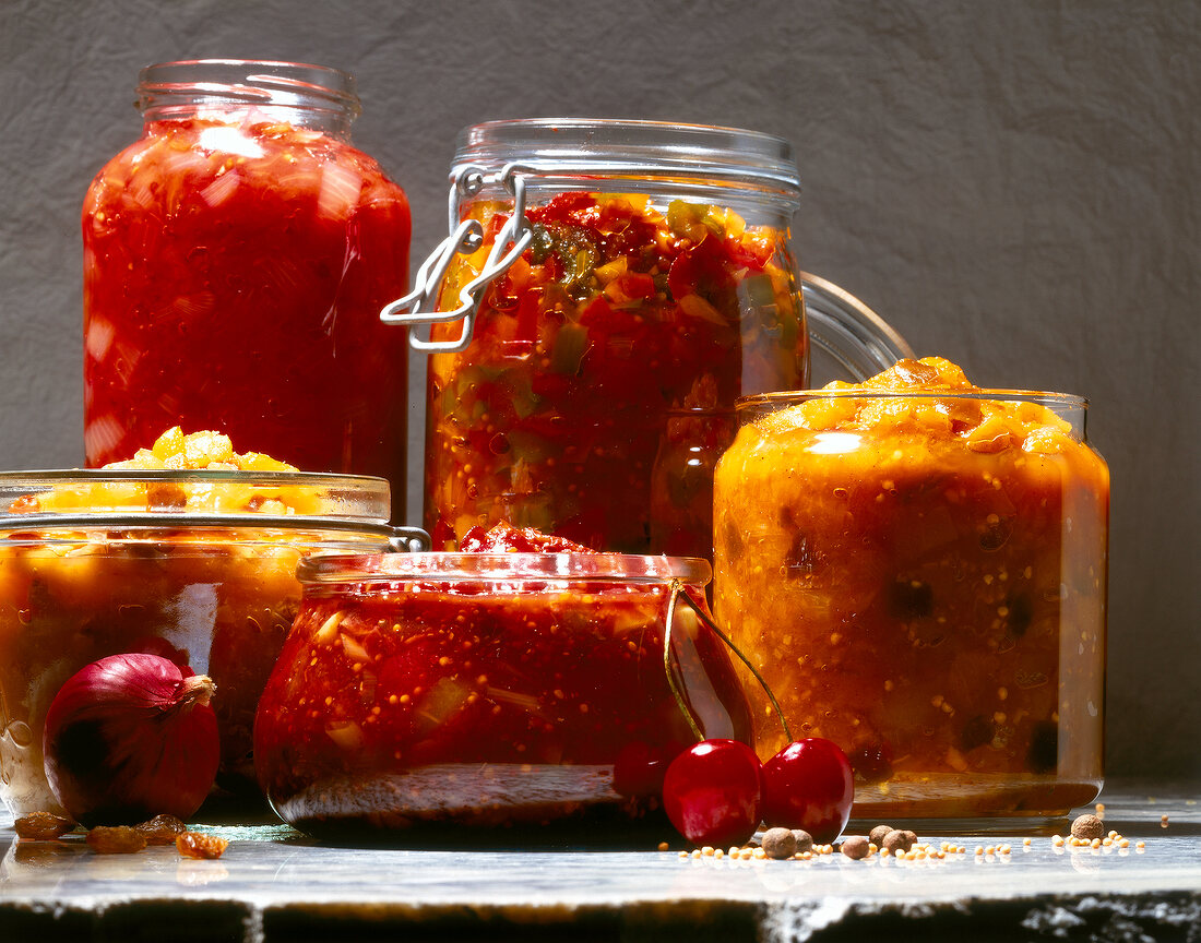 Different types of spicy chutney in glass jar