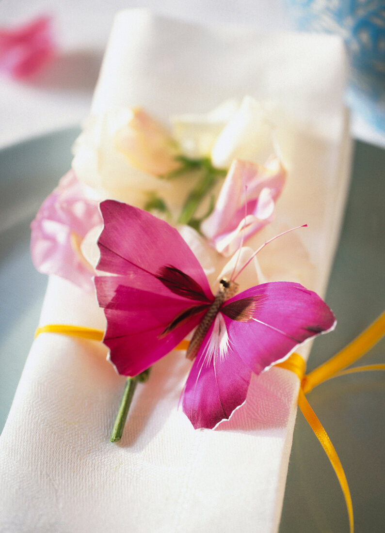 Close-up of handmade pink butterfly on napkin