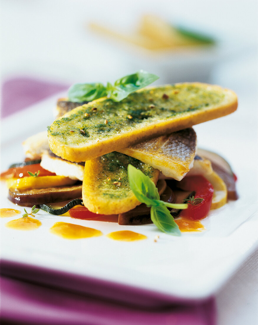 Close-up of burger of sea bass with vegetables on plate