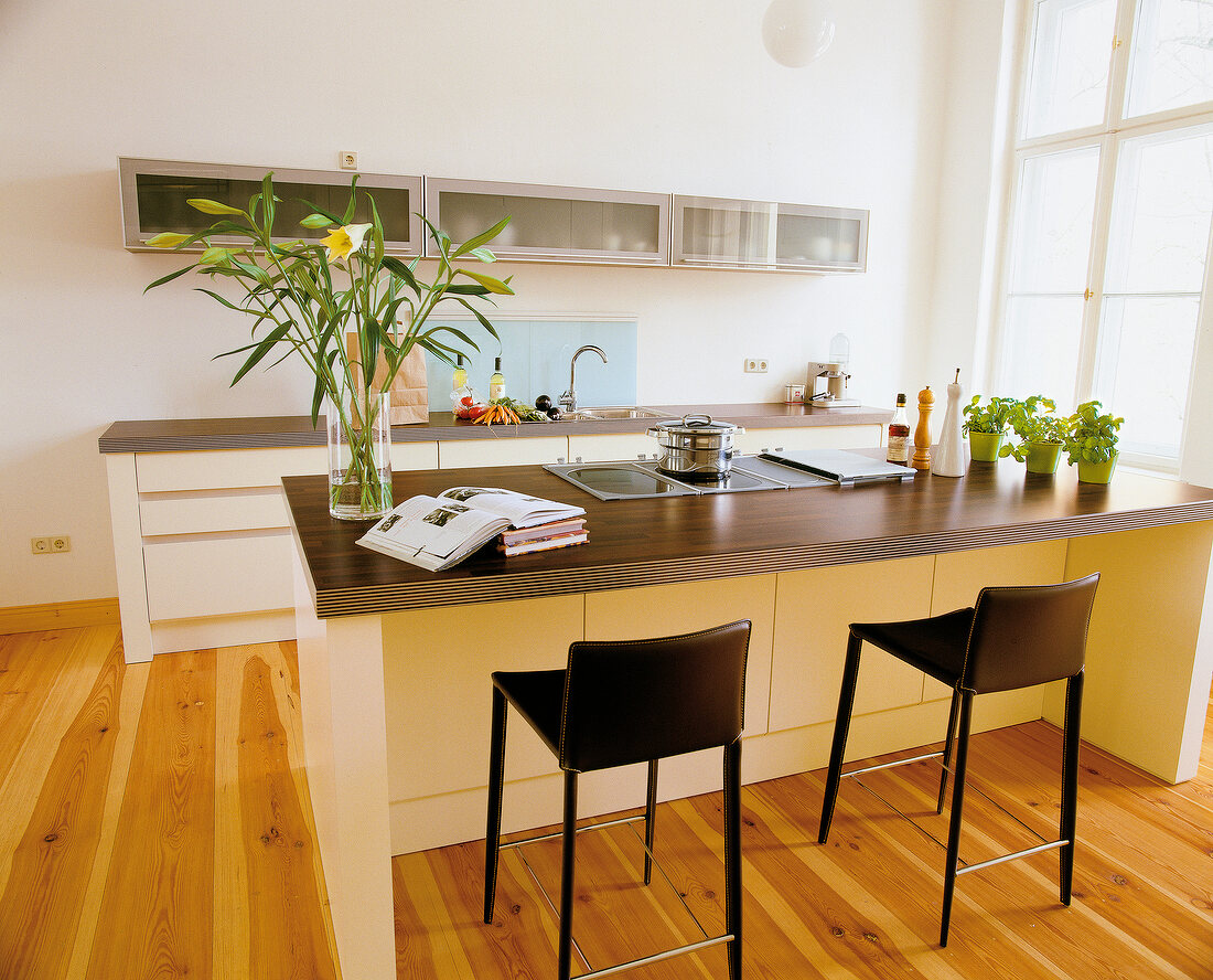 Kitchen with an island and eating bar with two chairs