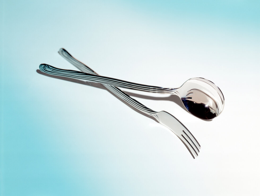 Spaghetti cutlery on blue background