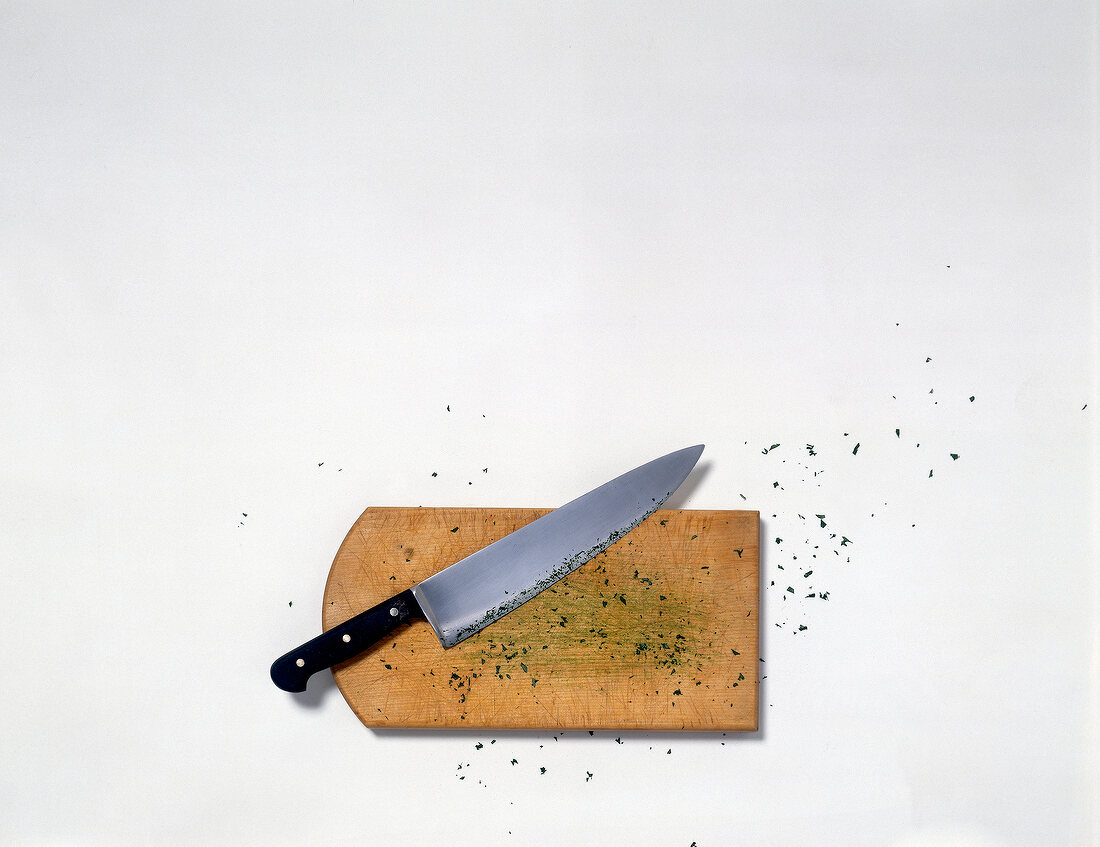 Kitchen knife on wooden cutting board