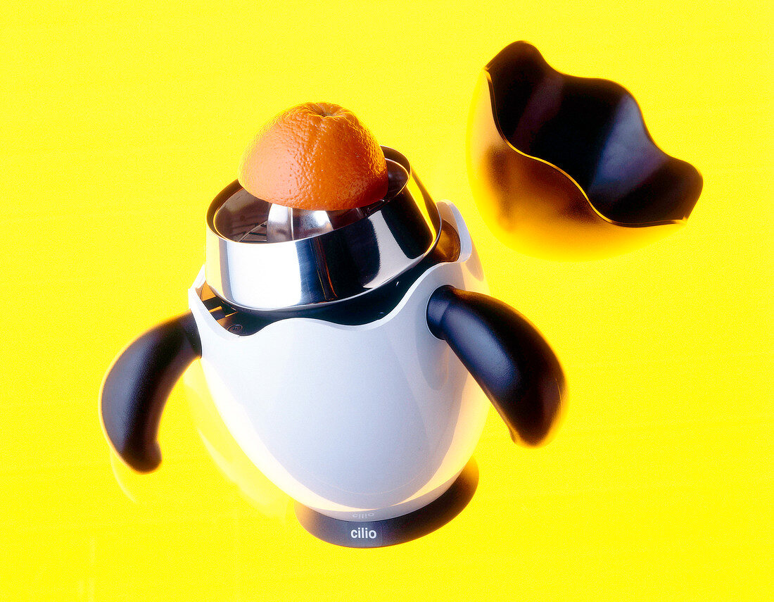 Citrus juicer in penguin form on yellow background