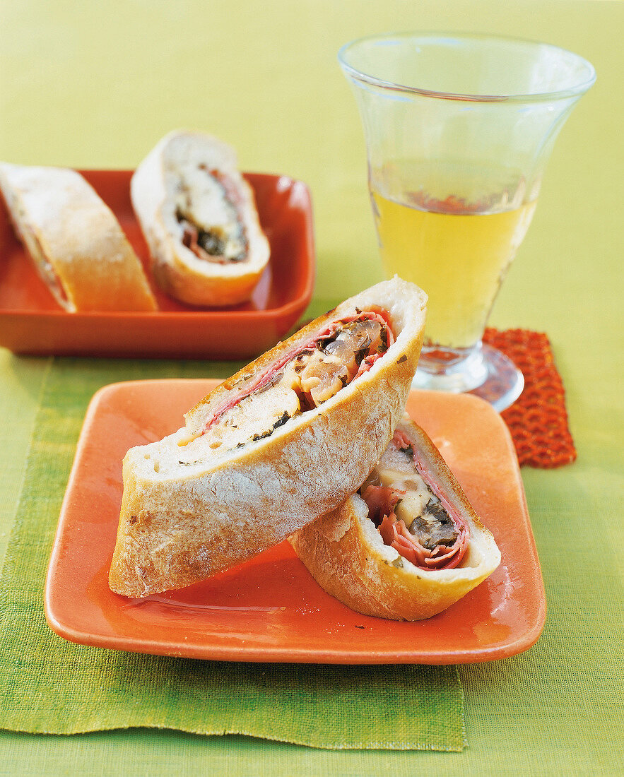 White bread with filling on orange plate, Switzerland