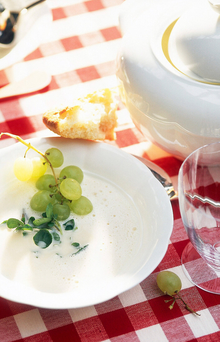 Cold garlic soup with grapes and watercress in bowl