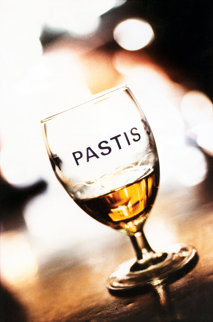 Glass of pastis on wooden table