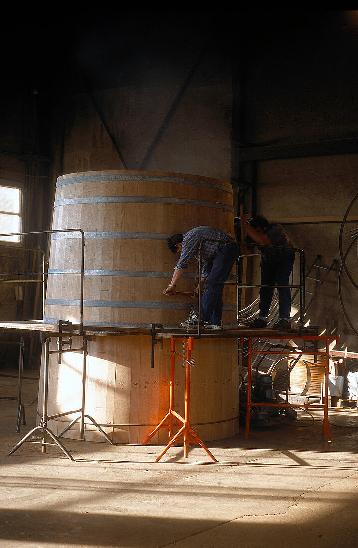 Man preparing giant wine barrel for storing 8000 wine