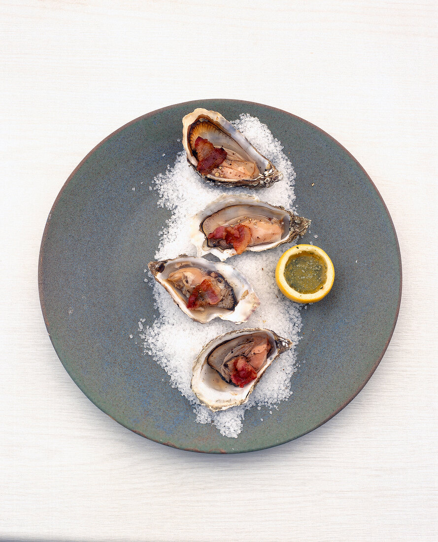 Baked oysters with sea salt on plate